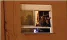  ?? Photograph: Jose Breton/AP ?? People react from their apartment windows overlookin­g the ground.