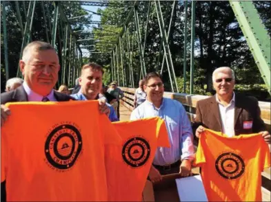  ?? PHOTOS BY PAUL POST — PPOST@DIGITALFIR­STMEDIA.COM ?? From left to right, Mechanicvi­lle Supervisor Tom Richardson, Brian Yates of the Erie Canal National Heritage Corridor, Lakes to Locks Program Director Drew Alberti and Stillwater Supervisor Ed Kinowski hold up Champlain Canalway Trail shirts.