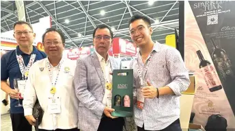  ?? ?? Dr Rundi (second right) with one of the exhibitors showcasing Sarawak’s products at the Sarawak Pavilion of the FHA – F&B 2024 exhibition in Singapore.