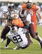  ?? NATE BILLINGS/FOR THE OKLAHOMAN ?? Oklahoma State’s LD Brown (0) is stopped for a loss by a group of Missouri State defenders Saturday night at Boone Pickens Stadium in Stillwater.