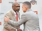  ?? AP ?? Ohio State athletic director Gene Smith, left, shakes hands with Chris Holtmann after naming Holtmann the basketball coach on June 12, 2017.