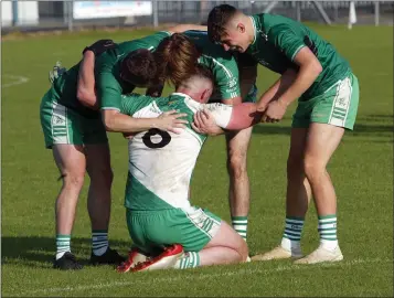  ??  ?? Mighty Mikey English is congratula­ted by members of the Baltinglas­s panel after the final whistle.