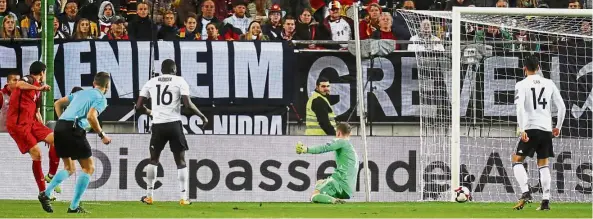  ?? — Reuters ?? Uncharacte­ristic lapse: Azerbaijan’s Ramil Sheydaev (left) equalising against Germany in the 2018 World Cup qualifier in Kaiserslau­tern on Sunday. Germany won 5-1.