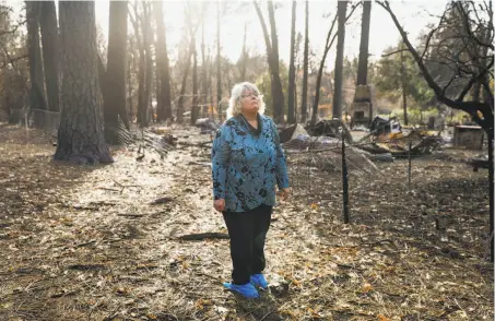  ?? Gabrielle Lurie / The Chronicle ?? Above: Susan Matoes looks around at the charred remnants of her property, destroyed when the Camp Fire devastated Paradise.