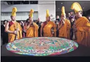  ??  ?? DEVOTION » The monks chant on Saturday over the mandala they created over a period of several days.