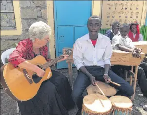  ?? CHRISTIAN ROACH/CAPE BRETON POST ?? Betty Jane Cameron of Mabou is seen at St. Charles Lwanga Secondary School in Nairobi, Kenya, last year, teaching a student the guitar.