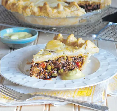  ?? ERIC AKIS ?? This meat pie features flaky pastry filled with a beef bourguigno­n-style mixture, rich with wine and mushrooms.