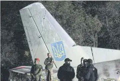  ??  ?? GRIM TOLL: Rescuers and experts work on the place of The Antonov An-26 aircraft crash at Chuhuiv military air base about 30km southeast of Kharkiv.