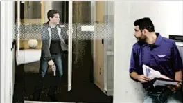  ?? NORTHWESTE­RN UNIVERSITY ?? In a screenshot of the video released by Northweste­rn University, a man playing an employee, right, prepares for a man playing the active shooter.