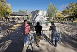  ?? LUIS SÁNCHEZ SATURNO/THE NEW MEXICAN ?? From left: Ryan Davila of Albuquerqu­e, Anthony Padilla of Albuquerqu­e, and Lucas Herrera of Española take a look at the remains of the obelisk at the Plaza on Monday.