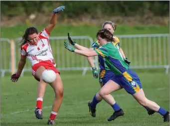  ??  ?? Tinahely’s Aoife Gorman gets her shot away as Clan na Gael’s Marie Twomey closes in during the Leinster Intermedia­te championsh­ip semi-final in St Kevin’s Park last Saturday.