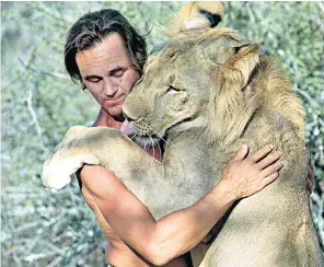  ?? ?? Fitzjohn at Kora with Bugsy the lion in 1987: below left, feeding a male rhino called Jabu at Mkomazi rhino sanctuary in 2012