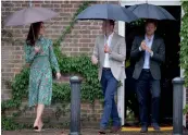  ?? — AP ?? Britain’s Prince William (centre), his wife Kate and Prince Harry arrive for an event at the memorial garden in Kensington Palace, London, on Wednesday.