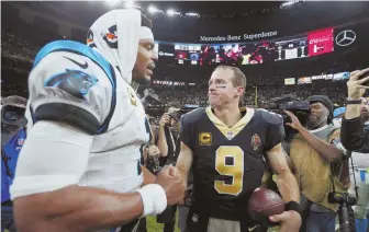  ?? Ap photo ?? iT’S Over: drew Brees (right) shakes hands with cam Newton after the Saints beat the Panthers yesterday in New Orleans.