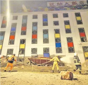  ?? Photo: AFP ?? Rescue workers search the damaged Marshal Hotel in Hualien, eastern Taiwan.