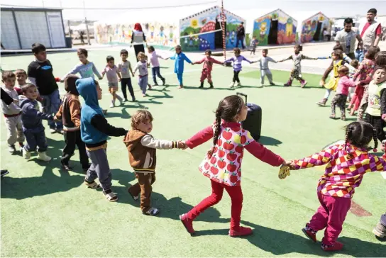  ??  ?? Displaced children who fled Mosul play outside their tents in a playground at the Hassan Sham Camp, 30 km from Mosul. (AFP)