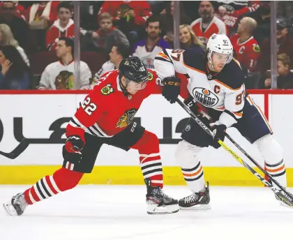  ?? JONATHAN DANIEL/GETTY IMAGES ?? In the NHL’S proposed 24-team Stanley Cup tournament, Ryan Carpenter, left, and the Chicago Blackhawks would face Connor Mcdavid and the Edmonton Oilers in a best-of-five playoff series to see who advances to the round of 16.