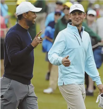  ?? AP PHOTO ?? MEETING A MASTER: Matt Parziale walks Augusta’s first fairway during a practice round with boyhood idol Tiger Woods at the Masters last week.