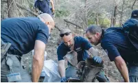  ?? (Yonatan Sindel/Flash90) ?? POLICE SAPPERS inspect the scene where a rocket fired from Gaza fell near houses in Beit Nekofa, outside Jerusalem, last week.