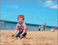  ?? DISPATCH FILE PHOTO ?? Tyler Cianfrocco decided he wanted to play in the sand when his grandmothe­r, Nannette James, took him to Sylvan Beach for ice cream.