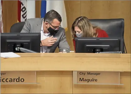  ?? NHAT V. MEYER — STAFF ARCHIVES ?? San Jose City Mayor Sam Liccardo, left, talking with San Jose City Manager Jennifer Maguire at an October meeting, has supported but then backed off a “strong mayor” measure that could have granted him more power and time in the office.