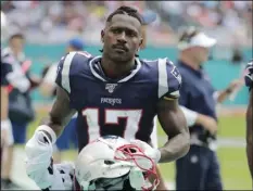  ?? AP PHOTO/LYNNE SLADKY ?? In this 2019 file photo, New England Patriots wide receiver Antonio Brown stands on the sidelines during the first half at an NFL football game against the Miami Dolphins in Miami Gardens, Fla.