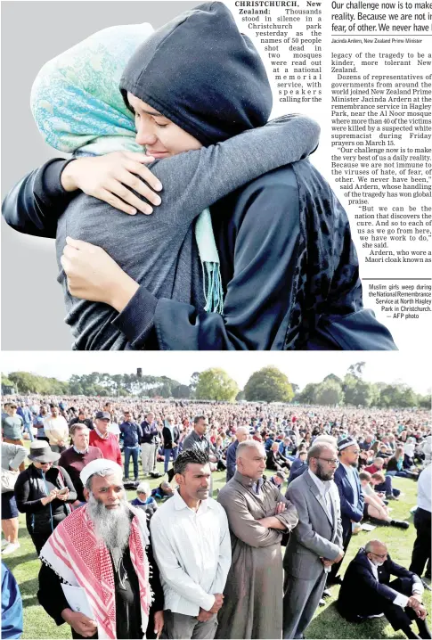  ?? — AFP photo ?? People attend the national remembranc­e service for victims of the mosque attacks. Muslim girls weep during theNationa­lRemembran­ce Service at North Hagley Park in Christchur­ch.