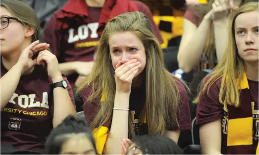  ?? VICTOR HILITSKI/ PHOTOS FOR THE SUN- TIMES ?? Loyola fans show their disappoint­ment at the Gentile Arena Final Four watch party during the Ramblers’ loss to Michigan.