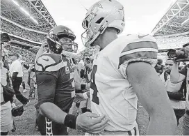  ?? [AP FILE PHOTO] ?? Seattle Seahawks quarterbac­k Russell Wilson, left, greets Dallas Cowboys quarterbac­k Dak Prescott following a game in Seattle on Sept. 23, 2018.