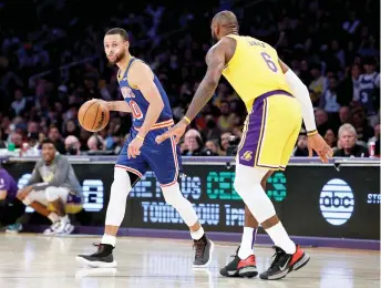  ?? — AFP photo ?? File photo shows Stephen Curry of the Golden State Warriors dribbles in front of LeBron James of the Los Angeles Lakers during a game.