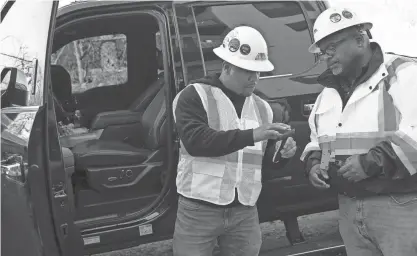  ?? ?? Robert Sherrill, CEO of Imperial Cleaning Systems, discusses supplies with Patrick Johnson, operations manager at a job site in East Nashville, Tenn.