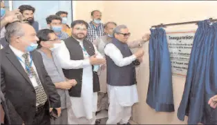  ?? LAHORE
-APP ?? Federal Minister for Education & Profession­al Training Shafqat Mahmood unveiling the plaque to inaugurate 220 KV Grid Station at NTDC Ghazi Road.