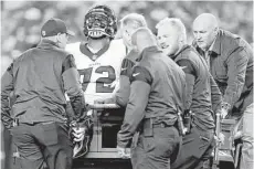  ??  ?? The anguish is apparent as Texans tackle Derek Newton is carted off the field after tearing both of his patellar tendons in the first half. He will need surgery on both knees and is out for the season.