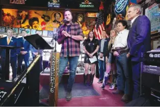  ?? AP PHOTO/MARK HUMPHREY ?? Country music star Luke Bryan speaks Thursday during a bill signing ceremony with Gov. Bill Lee, right, at Robert’s Western World, an historic honky tonk in downtown Nashville.