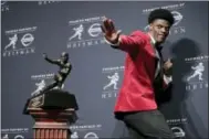  ?? JULIE JACOBSON - AP FILE ?? In this Dec. 10, 2016, photo, Louisville’s Lamar Jackson poses with the Heisman Trophy after winning the award, in New York. If anything, Heisman Trophy winner Lamar Jackson has been better this season than last, though he is not favored to repeat as...