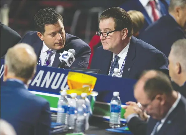  ?? — JASON PAYNE/POSTMEDIA FILES ?? Judd Brackett, left, here with Vancouver general manager Jim Benning at the NHL draft last June at Rogers Arena, had been with the Canucks for 12 years. He was named director of amateur scouting in August 2015, overseeing four drafts beginning in 2016.
