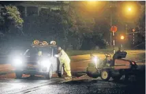  ?? Photo: ROBERT CHARLES/FAIRFAX NZ ?? Port Taranaki security staff speak with a contractor cleaning up the spillage along Ocean View Pde on Tuesday night.