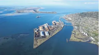  ?? PHOTO: SUPPLIED ?? Record cargo handling . . . South Port at Bluff, where paving of a 15,000sq m log storage area was completed on Island Harbour (pictured). The Tiwai Point aluminium smelter is in the background.