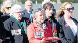  ??  ?? Private Williams’ twin sister, Jill McLean, holding her brother’s war medals, with his widow, Margaret, on the left.