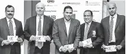  ??  ?? Harin Fernando, Minister of Telecommun­ication, Digital Infrastruc­ture, Foreign Employment and Sports, poses with the first day cover and stamp along with other distinguis­hed officials