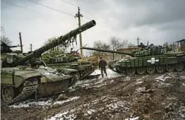  ?? LYNSEY ADDARIO/NEW YORK TIMES ?? Tanks are stationed in a village near the front line this week in eastern Ukraine. Russian forces are expected to make a major push to retake lost territory.