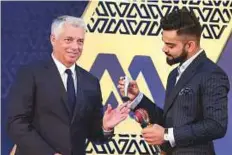  ?? PTI ?? Virat Kohli receives an award from David Richardson, CEO of ICC, during the BCCI Awards, in Bengaluru on Tuesday.