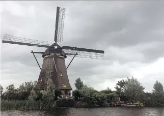  ?? JOHN MARSHALL/THE ASSOCIATED PRESS ?? The Kinderdijk windmills are still used to pump water from low-lying lands in the western Netherland­s and have become one of the country’s most popular tourist destinatio­ns.