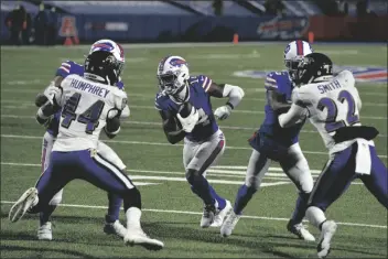  ?? ASSOCIATED PRESS ?? BUFFALO BILLS WIDE RECEIVER STEFON DIGGS (14) runs past Baltimore Ravens’ Marlon Humphrey (44) and Jimmy Smith (22) for a touchdown during the second half of an NFL divisional round game Saturday in Orchard Park, N.Y.