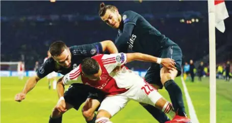 ??  ?? Real Madrid’s Gareth Bale (right) battling for ball possession with Hakim Ziyech of Ajax during their UEFA Champions League game in Amsterdam last night. Real Madrid won away 2-1 while Tottenham Hotspur defeated Borussia Dortmund 3-0