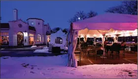  ?? (AP/Paul Sancya) ?? Diners eat in the parking lot of Red Crown in Grosse Pointe Park, Mich., on Wednesday. With virus cases dropping in the state, customers will be allowed to dine inside restaurant­s and bars starting Monday.