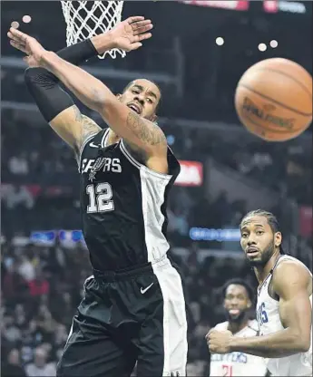  ?? Photograph­s by Wally Skalij Los Angeles Times ?? LaMARCUS ALDRIDGE of the Spurs, fouled by Kawhi Leonard in the first quarter, gave the Clippers fits as he and DeMar DeRozan provided a one-two punch to rival L.A.’s two-star attack.