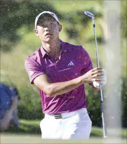  ?? The Maui News / MATTHEW THAYER photos ?? Collin Morikawa blasts out of a sand trap on the Kapalua Plantation Course’s 14th hole during the second round of the Sentry Tournament of Champions on Friday afternoon. Morikawa fired a 7-under 66 to take a two-shot lead into the weekend of the PGA Tour’s first event of 2023.