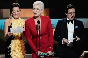  ?? Chris Pizzello / Associated Press ?? Michelle Yeoh, left, Jamie Lee Curtis and Ke Huy Quan accept the award for outstandin­g performanc­e by a cast in a motion picture for "Everything Everywhere All at Once," on Sunday at the Screen Actors Guild Awards in Los Angeles.