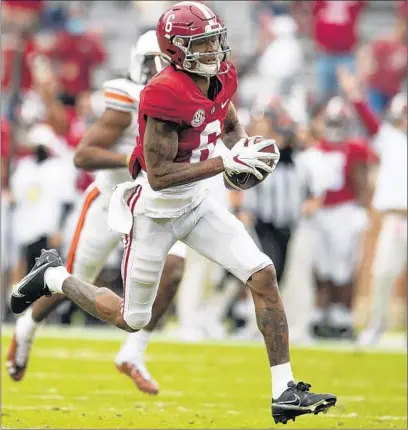  ?? MICKEY WELSH/AP ?? DeVonta Smith heads to the end zone for one his two long TDs catches during No. 1 Alabama’s victory over No. 22 Auburn on Saturday.